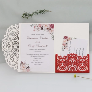 Detail of laser-cut wedding invitation with glitter insert and floral printed card
