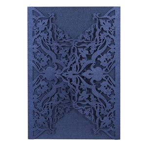 Navy blue laser-cut wedding invitation cover with elegant pearlized scroll pattern