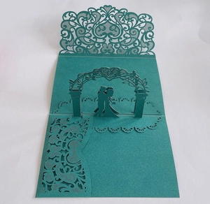 Macro view of laser-cut 3D bridal invitation card with teal paper and intricate details