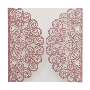 Detail of pink glitter laser-cut invitation card with elegant hollow floral patterns