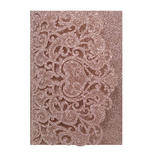 Intricate laser-cut floral wedding invitation in shimmering rose gold glitter finish