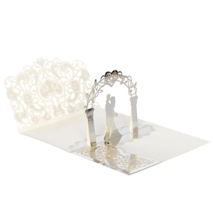 Macro view of 3D pop-up wedding invitation with laser-cut floral arch and silver foil