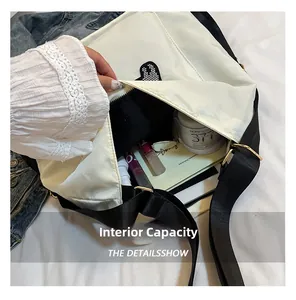 Detail view of the spacious interior capacity of this white cartoon crossbody bag