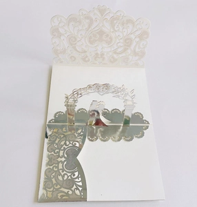 Close-up of 3D laser-cut wedding invitation featuring an arch and couple silhouette