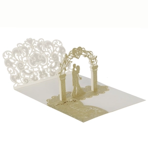 Detail of 3D laser-cut wedding invitation with golden glitter and hollow floral pattern