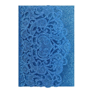 Detail of blue glitter laser-cut wedding invitation cover with intricate floral patterns