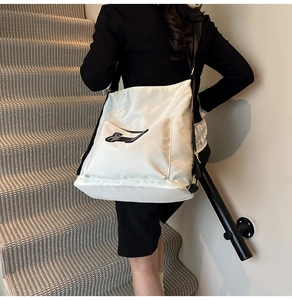 Macro detail of white nylon tote bag showing a cute black dachshund silhouette print
