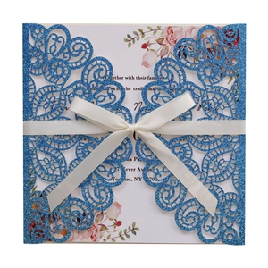 Sparkling blue laser cut wedding invitation with glitter finish and white satin bow