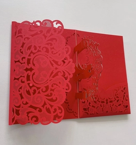 Detailed laser-cut floral pattern and 3D folding structure on a red wedding card