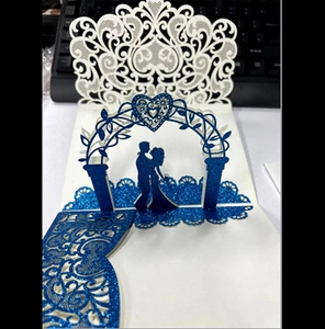 Detail showing 3D laser-cut wedding card with royal blue glitter and pop-up couple silhouette