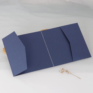 Detailed view of dark green textured paper card holder with a classic tri-fold structure