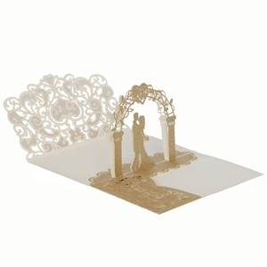 Detailed laser cut gold glitter wedding invitation showing 3D arch and floral patterns