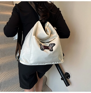 Detailed back view of a white nylon backpack featuring a cute dachshund sequin patch