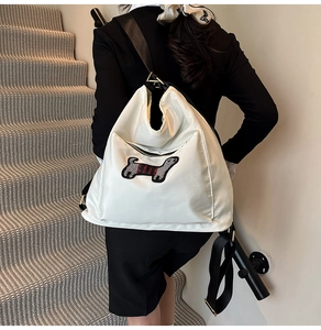 Detailed view of white nylon backpack with a cute cartoon dachshund embroidery patch