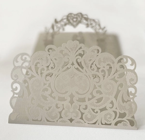 Detailed laser-cut wedding invitation card with elegant lace patterns and heart hollows