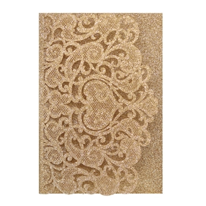 Close-up of golden glitter laser-cut wedding card featuring intricate lace heart details