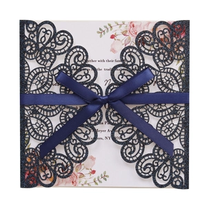 Laser-cut navy blue glitter wedding invitation with satin ribbon and floral insert card