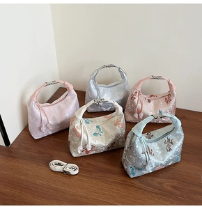 Detailed close-up of embroidered jacquard dumpling bags in five elegant pastel colors