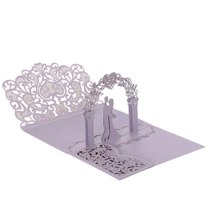 Detail of 3D pop-up wedding card with laser-cut floral patterns and romantic heart arch