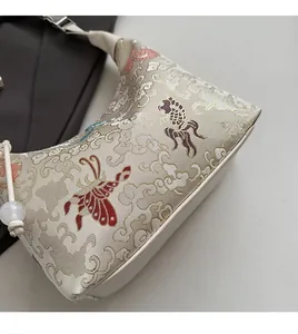 Close-up of cream white jacquard fabric with traditional Chinese embroidery on bag