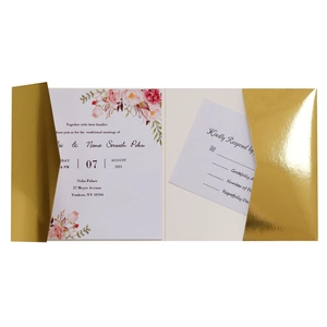 Detail of gold laser-cut wedding invitation with elegant floral RSVP card and envelope