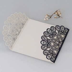 Detail of laser cut glitter invitation card with navy blue lace and cream insert