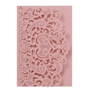 Detail of laser-cut floral scrollwork and heart pattern on dusty rose pearlescent paper