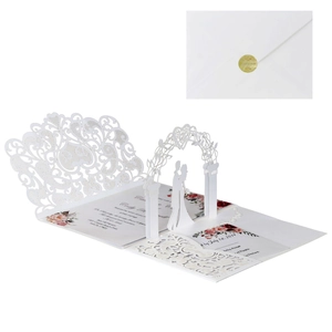 Detail of 3D laser-cut wedding invitation with hollow heart and floral paper carving