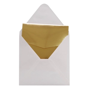 Detailed view of white minimalist open envelope with elegant gold inner lining card