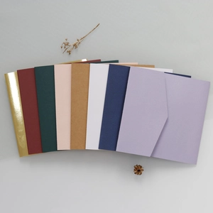 Detailed flat lay of colorful assorted envelopes with textured finish and metallic gold