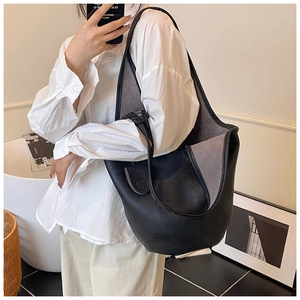 Close-up of black lychee grain leather bucket bag with soft grey suede interior lining