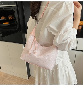 Detail of light pink floral jacquard embroidery on a retro shoulder bag with beads