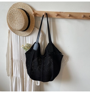 Détail du sac cabas au crochet noir avec anses en cuir et fermeture à cordon crème