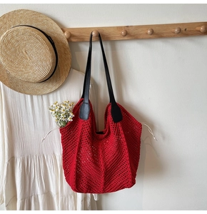 Détail du sac cabas en crochet rouge avec maille ajourée et cordons blancs