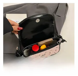 Detail view of the pink bow underarm bag interior capacity with magnetic closure