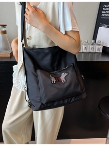 Black nylon bucket backpack with cartoon dog embroidery for school and daily commute