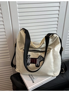 Chic beige nylon backpack for women featuring cute cartoon puppy patch with gold hardware