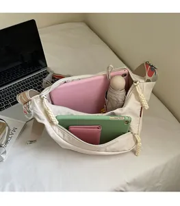 Large capacity nylon crescent bag showing spacious interior with tablet and accessories