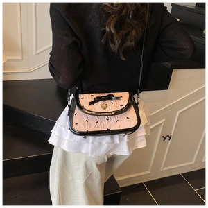 Detailed back view of a pink bow shoulder bag with black trim and heart pendant
