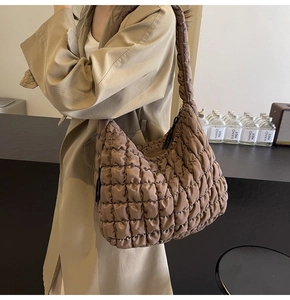 Close-up of brown quilted tote bag showing soft nylon texture and grid stitching detail