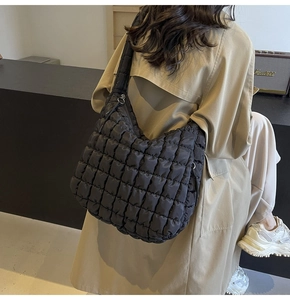 Detail of the black quilted texture and large capacity on the nylon tote bag