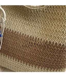 Macro shot of the bohemian woven straw tote bag showing detailed beige and brown textures