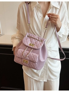 Elegant purple quilted leather backpack with gold chain straps and twist-lock closure