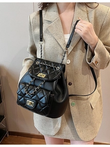 Quilted black leather backpack for women with gold chain handle and rhombus pattern