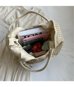 Top view of large capacity straw tote bag showing spacious fabric lining and zip closure