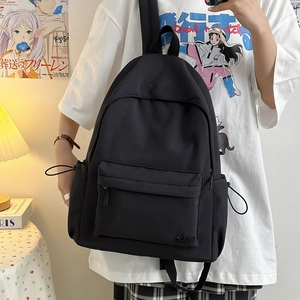 Dettaglio dello zaino in nylon nero con tasca laterale a coulisse e logo ricamato