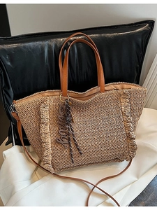 Fashionable woven straw tote bag for summer beach holidays with dual handles and strap