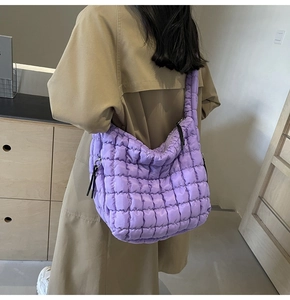 Close-up of a purple quilted tote bag showing the soft texture and stitch detail