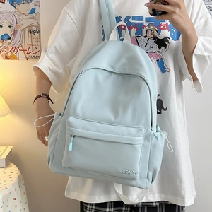 Dettaglio dello zaino in nylon azzurro con tasca frontale e logo GDMNO ricamato
