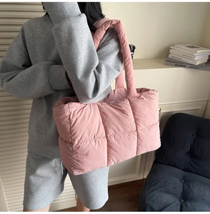 Detail showing the light pink quilted puffer tote bag with spacious interior and soft texture